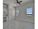 Bright bedroom with river view features stylish built-in desk/cabinets, tile floors and fan at 935 Chipaway Dr, Apollo Beach, FL 33572