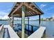 Covered boat lift on the water, offering a convenient and protected space for boating enthusiasts at 935 Chipaway Dr, Apollo Beach, FL 33572