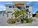 Beautiful two-story home with striking curb appeal, accentuated by lush landscaping and a modern exterior staircase at 935 Chipaway Dr, Apollo Beach, FL 33572