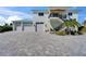 Stunning two-story waterfront home featuring a spacious three-car garage and beautifully landscaped front yard at 935 Chipaway Dr, Apollo Beach, FL 33572