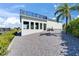 Home exterior boasting of an upper balcony, storage, and waterfront access for outdoor relaxation and activities at 935 Chipaway Dr, Apollo Beach, FL 33572