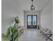 Bright foyer features stylish decor, wood-look tile flooring, and double doors leading to outdoor views at 935 Chipaway Dr, Apollo Beach, FL 33572
