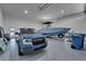 Spacious garage showcasing a blue truck, boat, and speckled floors, offering ample storage and functionality at 935 Chipaway Dr, Apollo Beach, FL 33572