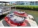 Two red jet skis parked on a floating dock, ready for fun on the water near the beautiful waterfront property at 935 Chipaway Dr, Apollo Beach, FL 33572