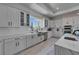Bright, modern kitchen with stainless steel appliances, white cabinetry, and marble countertops at 935 Chipaway Dr, Apollo Beach, FL 33572