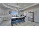 Modern kitchen featuring white cabinets, stainless steel appliances, a blue island, and sleek countertops at 935 Chipaway Dr, Apollo Beach, FL 33572