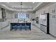 Modern kitchen featuring white cabinets, stainless steel appliances, a blue island, and sleek countertops at 935 Chipaway Dr, Apollo Beach, FL 33572