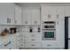 Bright kitchen with white cabinets, stainless steel appliances, and elegant countertops at 935 Chipaway Dr, Apollo Beach, FL 33572