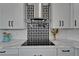 Stylish kitchen featuring modern appliances and a unique backsplash design at 935 Chipaway Dr, Apollo Beach, FL 33572