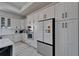 Modern kitchen featuring sleek white cabinetry, stainless steel appliances, and stylish countertops at 935 Chipaway Dr, Apollo Beach, FL 33572