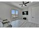 Living room featuring wood-look tile floors, neutral paint, and a sliding glass door to a private balcony at 935 Chipaway Dr, Apollo Beach, FL 33572