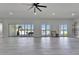 Expansive living area features light tile floors, high ceilings and doors to outdoor living at 935 Chipaway Dr, Apollo Beach, FL 33572