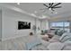 Spacious living room boasts modern design, comfy sectional, natural light, and seamless access to outdoor views at 935 Chipaway Dr, Apollo Beach, FL 33572