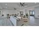 Open-concept living room featuring comfortable seating, dining area, and bright blue double doors with water views at 935 Chipaway Dr, Apollo Beach, FL 33572