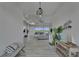 Open living space featuring modern decor, plenty of seating, and panoramic water views through sliding glass doors at 935 Chipaway Dr, Apollo Beach, FL 33572
