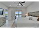 Bright main bedroom boasts a ceiling fan, light wood floors, and water views from the private balcony at 935 Chipaway Dr, Apollo Beach, FL 33572