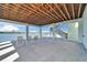 Waterfront patio with exposed beam ceiling, offering serene views and a relaxing space by the water at 935 Chipaway Dr, Apollo Beach, FL 33572