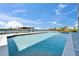 Tranquil pool offering a refreshing escape with a covered dock and picturesque water views for ultimate relaxation at 935 Chipaway Dr, Apollo Beach, FL 33572