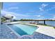 Backyard featuring a pool and dock, perfect for enjoying waterfront living and outdoor activities at 935 Chipaway Dr, Apollo Beach, FL 33572