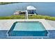 Aerial view of a backyard pool and boat dock, perfect for relaxation and enjoying waterfront activities and beautiful scenery at 935 Chipaway Dr, Apollo Beach, FL 33572