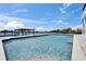 Backyard pool overlooking the canal with a boat dock and lift providing convenient access to the water for boating and recreation at 935 Chipaway Dr, Apollo Beach, FL 33572
