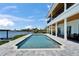 Inviting backyard pool with waterfront views, offering a luxurious and relaxing outdoor experience with a covered patio at 935 Chipaway Dr, Apollo Beach, FL 33572
