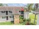 Condo balcony with green door, black rails, and lush green landscaping at 9851 113Th St # 206, Seminole, FL 33772