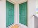 Condo front door with bright green paint, gold hardware, and a welcome mat at 9851 113Th St # 206, Seminole, FL 33772