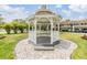 Charming white gazebo on a manicured lawn, perfect for outdoor relaxation and community enjoyment at 9851 113Th St # 206, Seminole, FL 33772