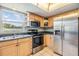 Bright kitchen featuring stainless steel appliances, light wood cabinets, and a window over the sink at 9851 113Th St # 206, Seminole, FL 33772