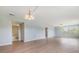 Spacious living room with wood flooring and a view to the bathroom and window at 9851 113Th St # 206, Seminole, FL 33772