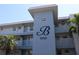 Exterior view of a condominium building with a large 'B' and the address 9950 displayed at 9950 47Th N Ave # 311, St Petersburg, FL 33708