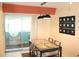 Dining area with a glass table, seating for six, and sliding glass door to balcony at 9950 47Th N Ave # 311, St Petersburg, FL 33708