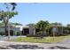 Well-maintained building featuring lush landscaping, manicured lawns, and clear signage near parking at 9950 47Th N Ave # 311, St Petersburg, FL 33708