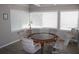 Bright game room featuring a poker table, six chairs, and natural lighting from large windows at 9950 47Th N Ave # 311, St Petersburg, FL 33708