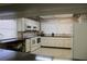 Well-equipped community kitchen featuring modern appliances, ample counter space, and abundant natural light at 9950 47Th N Ave # 311, St Petersburg, FL 33708