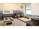 Efficient kitchen with white cabinets, classic appliances, and a practical layout at 9950 47Th N Ave # 311, St Petersburg, FL 33708