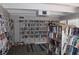 Community library with rows of bookshelves, comfortable seating, and natural light from the windows at 9950 47Th N Ave # 311, St Petersburg, FL 33708