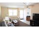 Bright living room with tile flooring, a ceiling fan, and a comfortable neutral-colored sofa at 9950 47Th N Ave # 311, St Petersburg, FL 33708