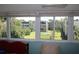 Relaxing outdoor view from the window overlooking lush landscaping, a pool, and other condominium buildings at 9950 47Th N Ave # 311, St Petersburg, FL 33708