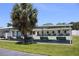 Outdoor recreation space featuring covered shuffleboard, benches, and a large palm tree for shade at 9950 47Th N Ave # 311, St Petersburg, FL 33708