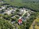 Overhead shot of a home with a pool nestled in a lush, tree-filled neighborhood setting at 10 Greenhaven Cir, Oldsmar, FL 34677
