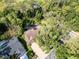 Beautiful aerial view of home nestled among mature trees, pool, and surrounding lush landscape at 10 Greenhaven Cir, Oldsmar, FL 34677