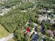 Birds-eye view of a house with pool, surrounded by trees, located in a serene, green-filled neighborhood at 10 Greenhaven Cir, Oldsmar, FL 34677