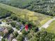 Aerial view of house with pool and wooded lot, marked with location pin in verdant neighborhood at 10 Greenhaven Cir, Oldsmar, FL 34677
