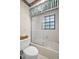 Bathroom showcases a toilet with a sliding glass-door shower, offering a blend of utility and space-saving design at 10 Greenhaven Cir, Oldsmar, FL 34677