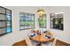 Cozy dining area featuring three windows with views of the pool and backyard at 10 Greenhaven Cir, Oldsmar, FL 34677