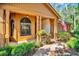 Charming entrance with decorative wood accents and colorful plants at 10 Greenhaven Cir, Oldsmar, FL 34677