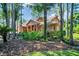 Charming home with well-manicured lawn, mature trees, and an American flag at 10 Greenhaven Cir, Oldsmar, FL 34677