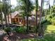 Charming single-story home with a welcoming porch and lush landscaping surrounding the property at 10 Greenhaven Cir, Oldsmar, FL 34677